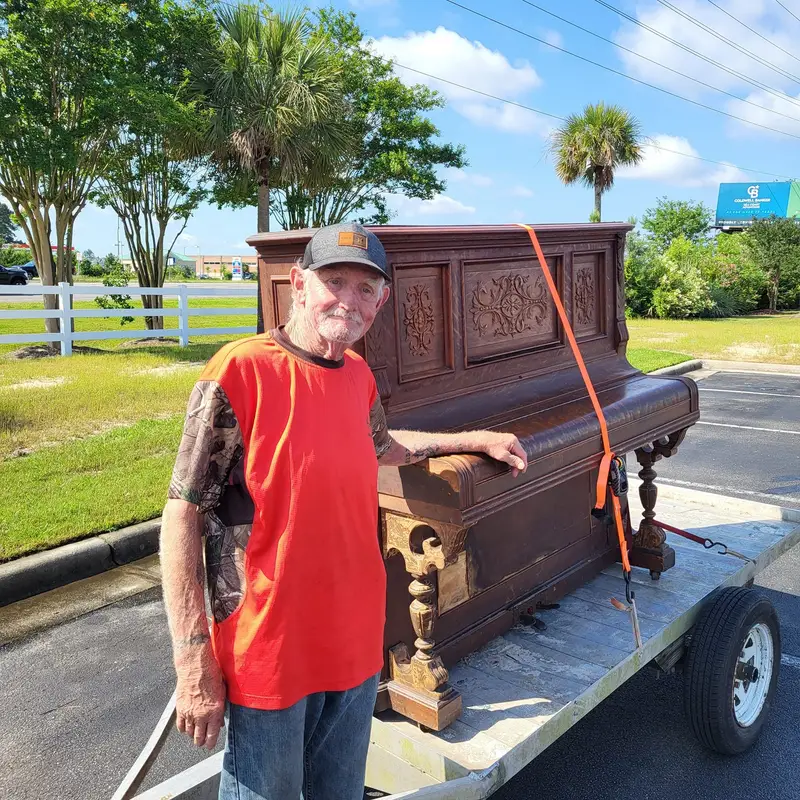 Allen Walker with an upright piano on a trailer: ‘the piano has been drinking’