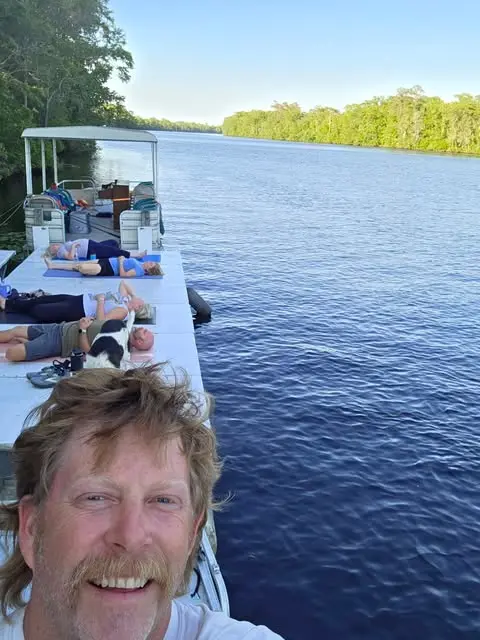 Allen Walker smiling on the dock with the wide Northeast Cape Fear River behind him